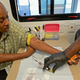 A woman, Tyshuanna Jackson, gets blood drawn for HIV/AIDS and STD testing at Los Angeles health fair. (Kevork Djansezian/Getty)